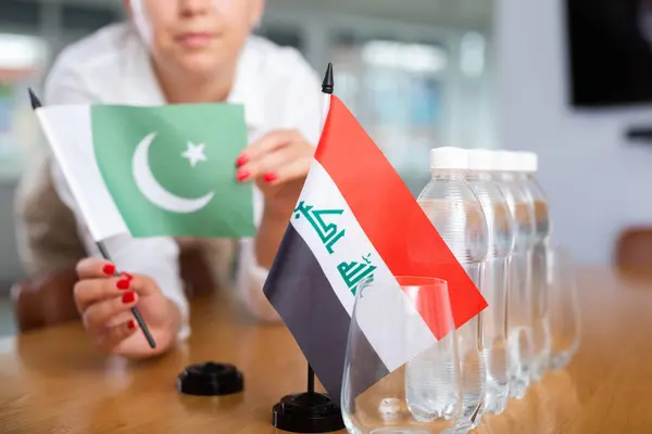 Businesswoman Arranging Flags Iraq Pakistan Presentation Negotiations — Stock fotografie
