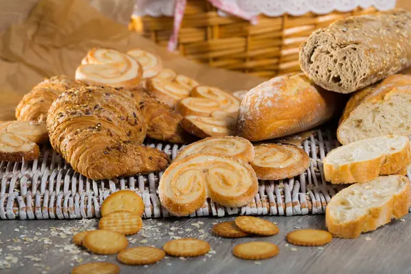 Various Bakery Pastry Products Rattan Mat Wooden Table — Stock Photo, Image