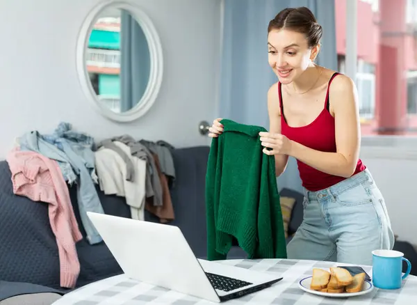 Young Caucasian Woman Fitting Clothes Front Her Laptop Video Call Stock Picture