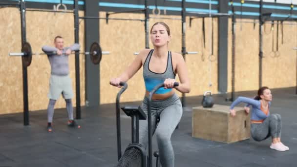Girl Performs Exercises Stationary Bicycle Female Gym Visitor Performs Series — Stock Video