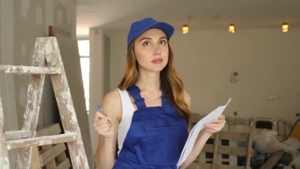 Positive Young Woman Builder Checking Documents Repair Works Indoors — Stock Video