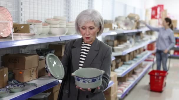 Positive Senior Female Shopper Choosing Interest Oriental Style Porcelain Soup — Stockvideo