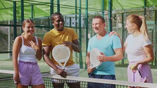 Four Confident Padel Tennis Players Standing Outdoor Court Rackets Balls — Stock Video