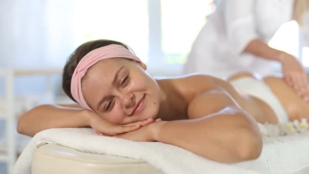 Smiling Young Woman Relaxing Massage Table Spa Salon While Skilled — Stock video