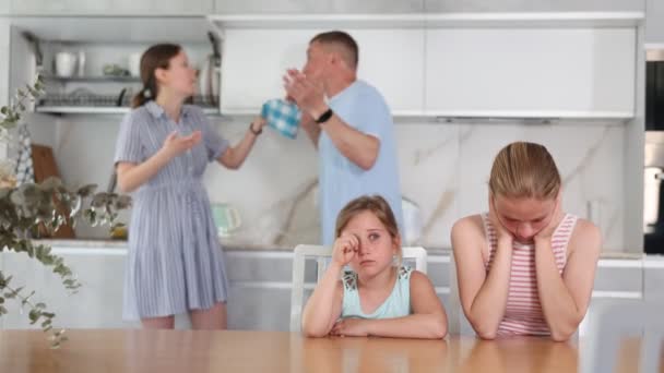 Dispirited Upset Teenage Girls Sitting Table Home Kitchen Covering Ears — Stockvideo