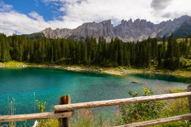 Wonderful colors of Lake Carezza and its view of Latemar mountain range clipart