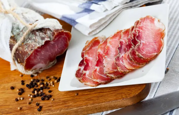 stock image Popular dish of Belarusian cuisine is an appetizing dried pork meat polendvica, cut into pieces and laid out on a plate