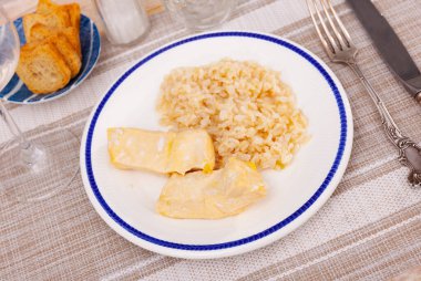 On plate is portion of boiled basmati rice and pieces of stewed, baked chicken breast, or fillet. Homemade lunch, healthy diet food clipart