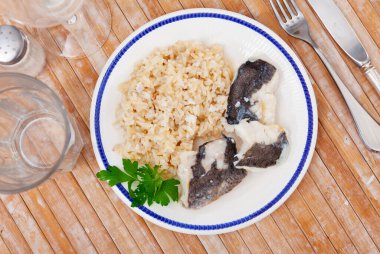 Tender meat of baked cod fillet is garnished with boiled basmati rice. Hearty and easy-to-prepare lunch and dinner. clipart