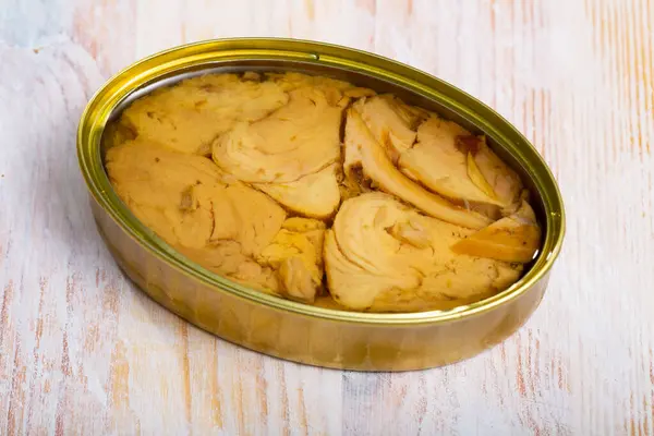 Stock image Canned tuna with parsley and lemon on a wooden table. High quality photo