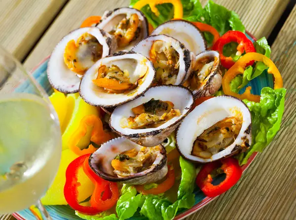 stock image Delicious baked in oven Dog cockles bivalve shellfishes served with greens and vegetables