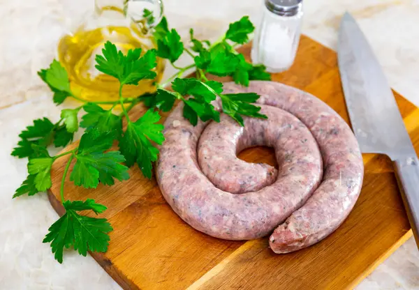 stock image Raw homemade sausage, ready for frying. Homemade sausage is made from several varieties of selected meat and using olive oil, spices and fresh herbs