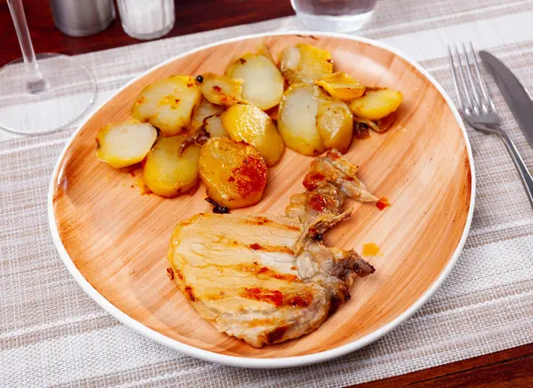 stock image Grilled pork chop steak on plate served with boiled potatoes