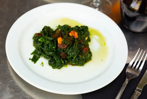 stock image Catalan Spinach served on table with decanter of red wine