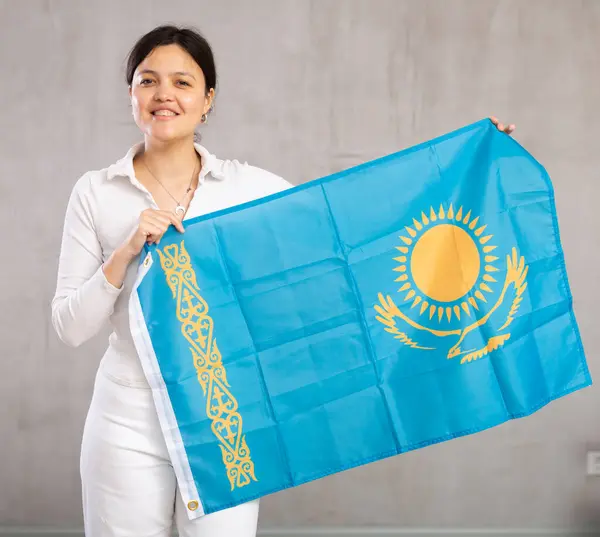 stock image Joyful female fan of the favorite team of Kazakhstan with the national flag in her hands