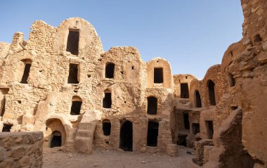 Unoccupied courtyard and house territory in ancient village of Berbers. Gsar of Mgabla, Tatahouine. Traditional type of Arab Muslim village in North Africa. Legacy of past, preserved to present day. clipart