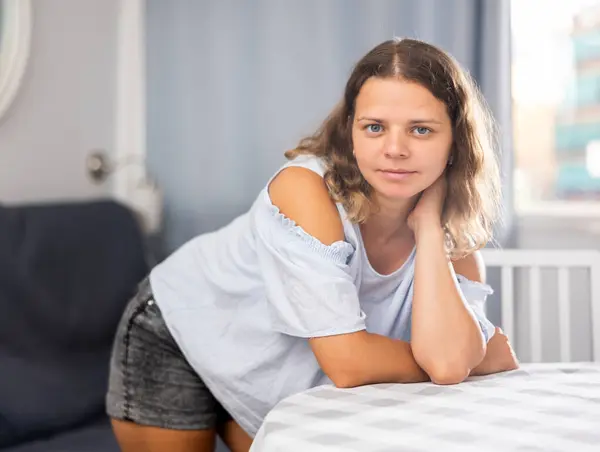 stock image Positive girl dressed tee-shirt and tight shorts in at room