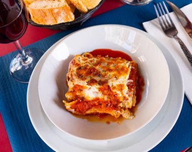 Popular dish of Italian cuisine is lasagna a la Bolognese with bechamel sauce clipart