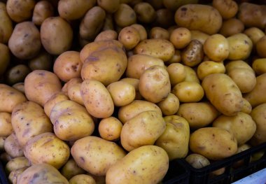 Raw potato in box on display at farmers market clipart