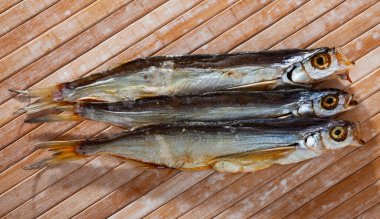 Image of air-dried salted sabrefish on wooden background, nobody clipart