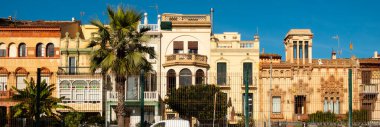 Street view of Catalan city of Vilassar de Mar on warm sunny winter day, Maresme, Spain.. clipart