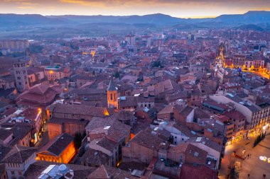 Aerial view of historic district of Vic town with ancient cathedral on winter twilight, Catalonia, Spain.. clipart