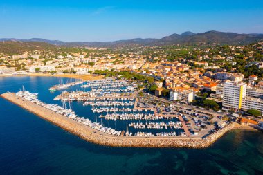 Picturesque view from drone of Sainte-Maxime townscape on Mediterranean coast with port for pleasure yachts on sunny autumn day, France clipart