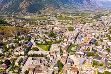 Aerial view of Martigny modern cityscape in Rhone Valley at foot of Swiss Alps in sunny summer day, canton of Valais clipart