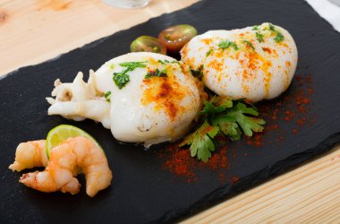 Dish of Mediterranean cuisine - roasted cuttlefish with paprika and parsley clipart