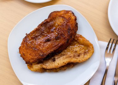 Fried bread with milk, egg and sugar Torrijas. Typical Spanish Easter sweet clipart