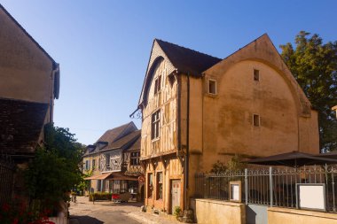 View of typical street in old historic district of Provins town in France on summer day overlooking ancient wooden timber-framed houses clipart