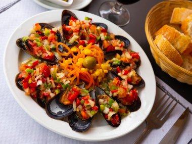 Tasty mussels with vinaigrette from fresh vegetables served at plate clipart