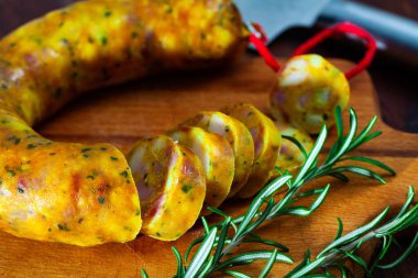 Spanish sausage butifarra on a wooden table, closeup clipart