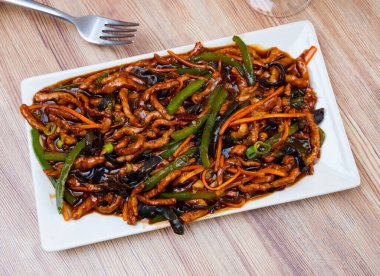 Chinese cuisine dish - appetizing yuxiang shredded pork with carrots and green beans served on plate clipart