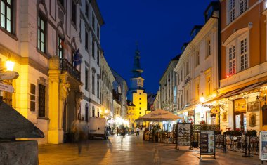 Bratislava, Slovakia - November 05, 2024: Picturesque pedestrian Michalska street in the evening in Bratislava old town with Michael tower in background clipart