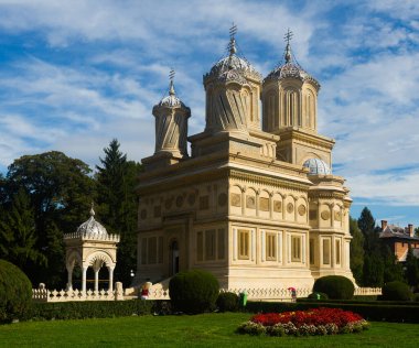 View of Romanian Orthodox Cathedral of Curtea de Arges in sunny autumn day clipart