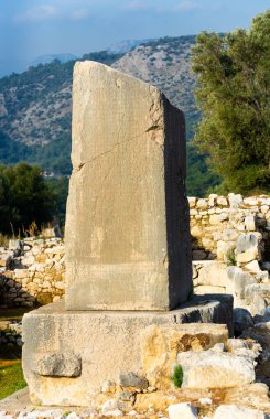 Remained Xanthian Obelisk or Xanthus Stele, stone pillar with inscriptions in Lycian and Greek in ancient city of Xanthos near modern town of Kinik, Turkey clipart