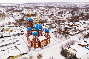 Aerial view of Church of the Intercession and residental quarters in winter in the city Petrovsk, Russia. clipart