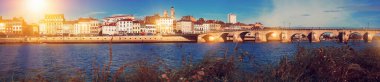 Panoramic view of city of Macon with Saone river on sunny autumn day, Burgundy, France.. clipart