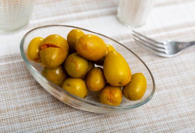 Pickled green olives with a stone - a typical Spanish tapas clipart