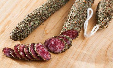 Sliced spanish sausage fuet with herbs clipart