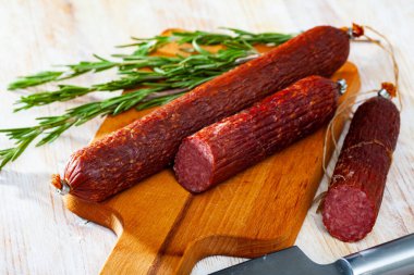 Close-up of smoked russian sausage at wooden surface, nobody clipart