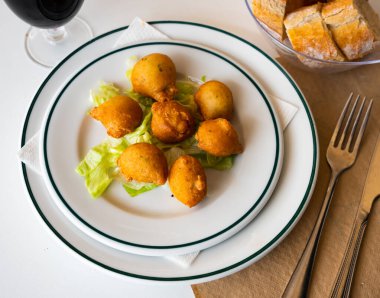 Bunuelos de bacalao - traditional Spanish cod fritters clipart