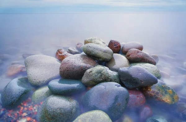 Stock image Beautiful seascape nature composition. Round rocks on the sea stones shore