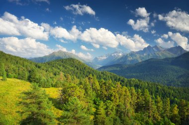 Dağ vadisinde bir manzara ve gündüz bulutlu mavi bir gökyüzü. Doğa manzarası.