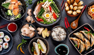 Traditional Asian food. Various of asian meals on dark background. Assorted dishes of traditional cuisine. Top view clipart