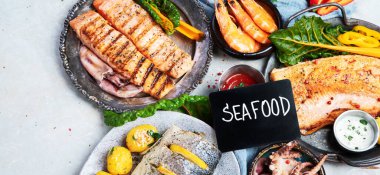 Deniz ürünleri tabağı. Gri arka planda sebzeli lezzetli deniz ürünleri. Üst Manzara. Kopya spreyle Panorama.