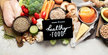 Healthy food selection on white background. Detox and clean diet concept. Foods high in vitamins, minerals and antioxidants. Anti age foods. Top view. Panorama with copy space.