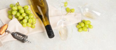 Flat-lay of white wine in glasses and corkscrews on a white background, top view, wide composition. Wine bar, winery, wine degustation concept. Panorama.