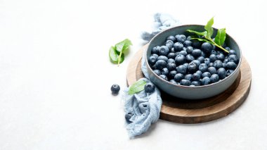Fresh blueberry on neutral background. Vegan and vegetarian concept. Top view, copy space